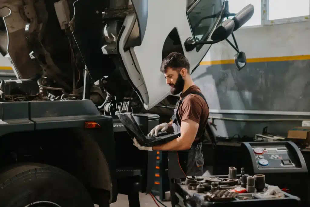 mechanic-using-laptop-to-diagnose-truck-problem