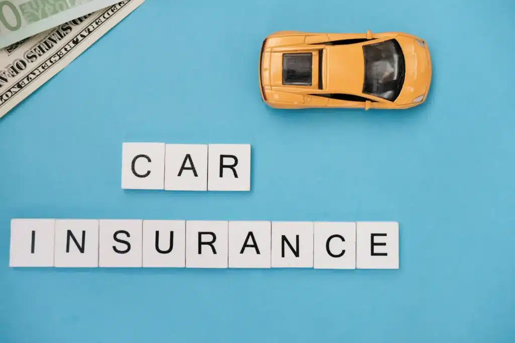 Car Insurance Concept with Model Car and Money