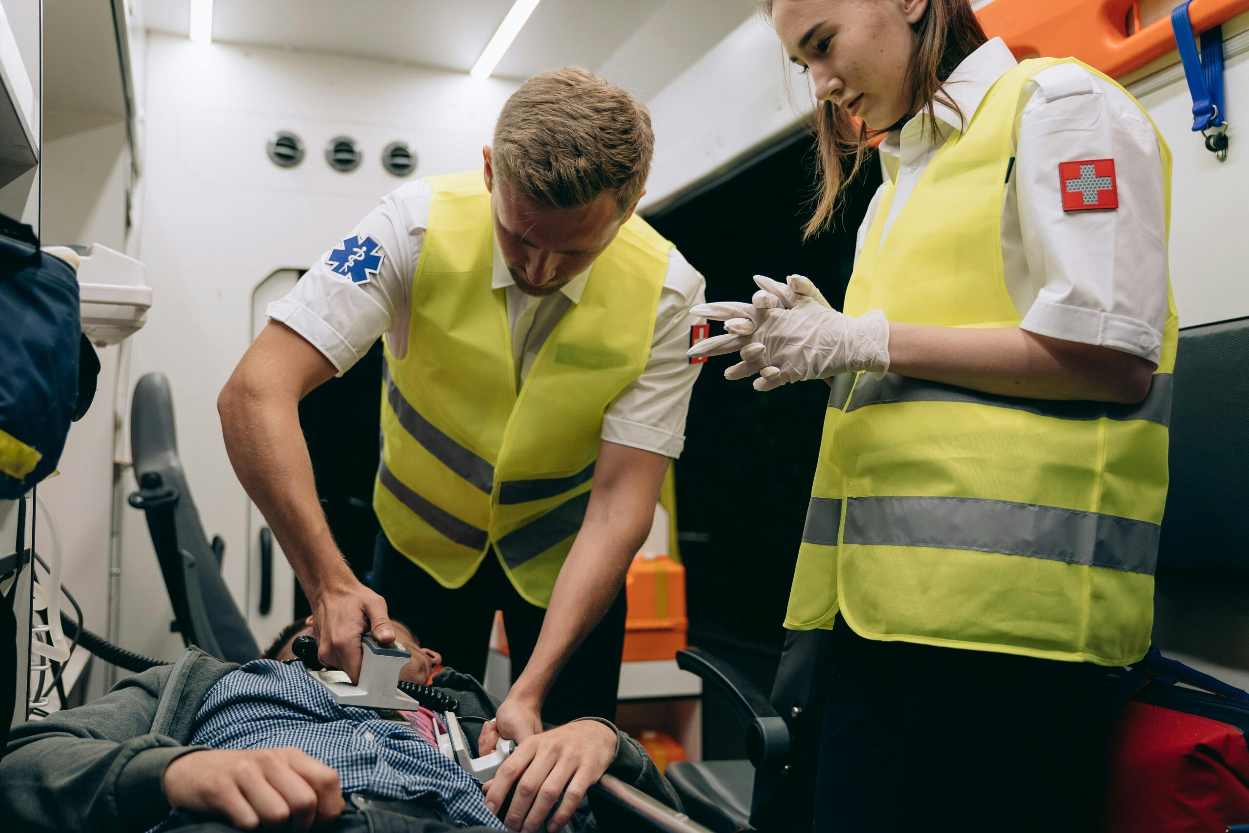 EMTs using a defibrillator