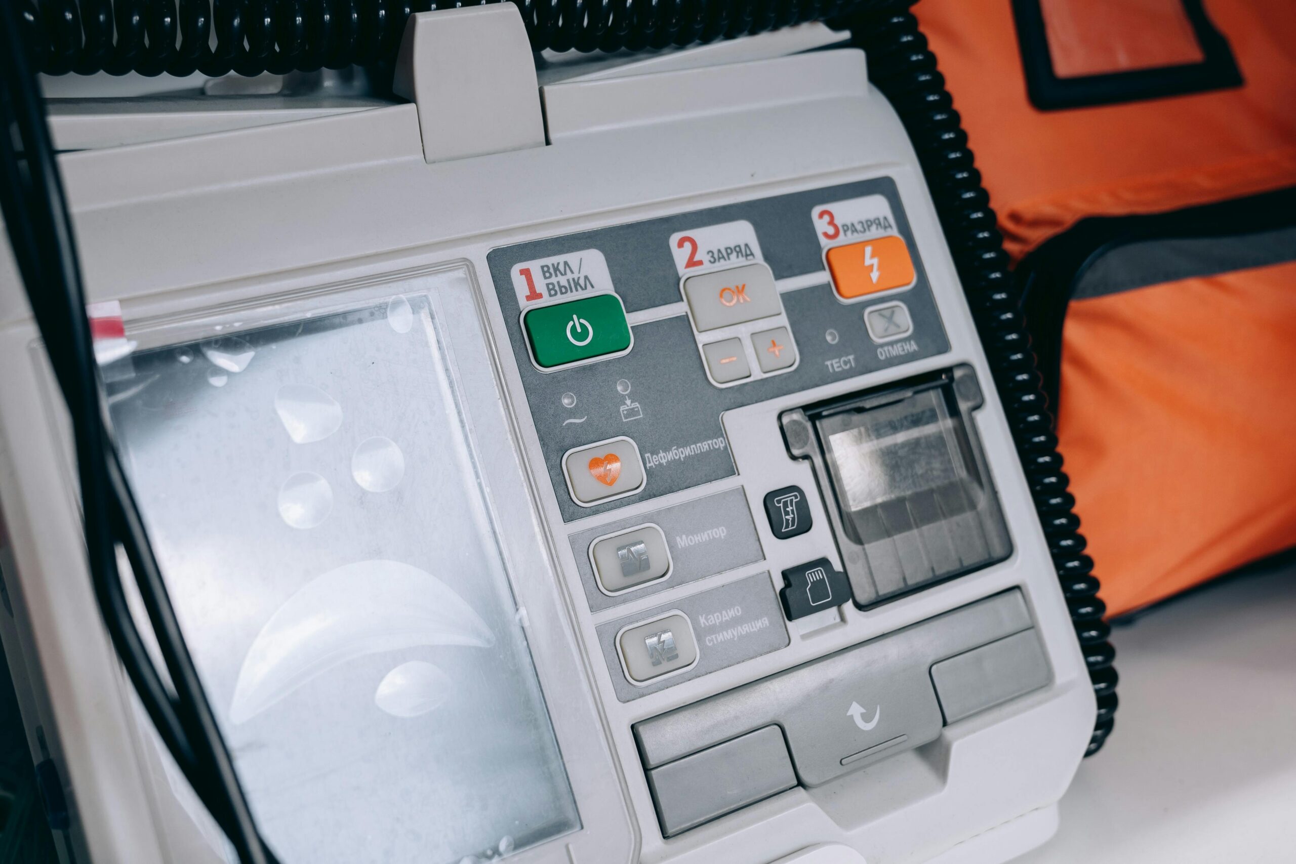 Gray AED with orange bag