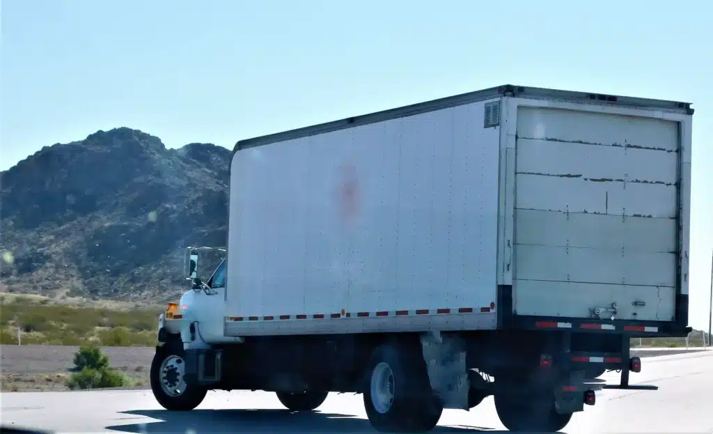 budget delivery-truck-traveling-on-the-roadway-through-de-