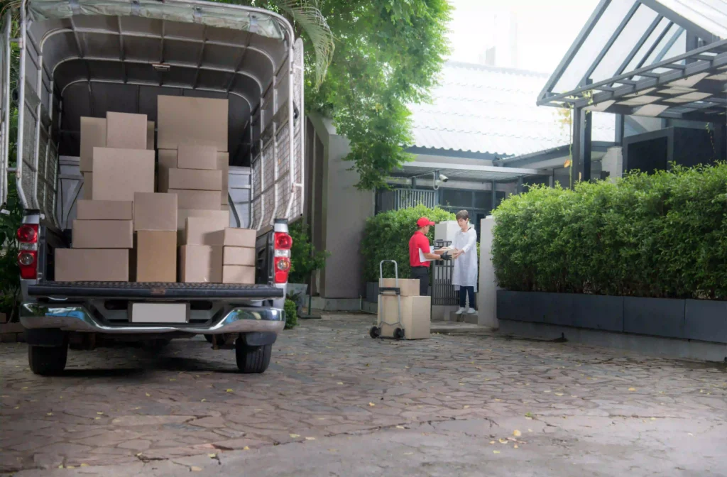 delivery-worker-delivering-boxes-to-a-suburban-hom-