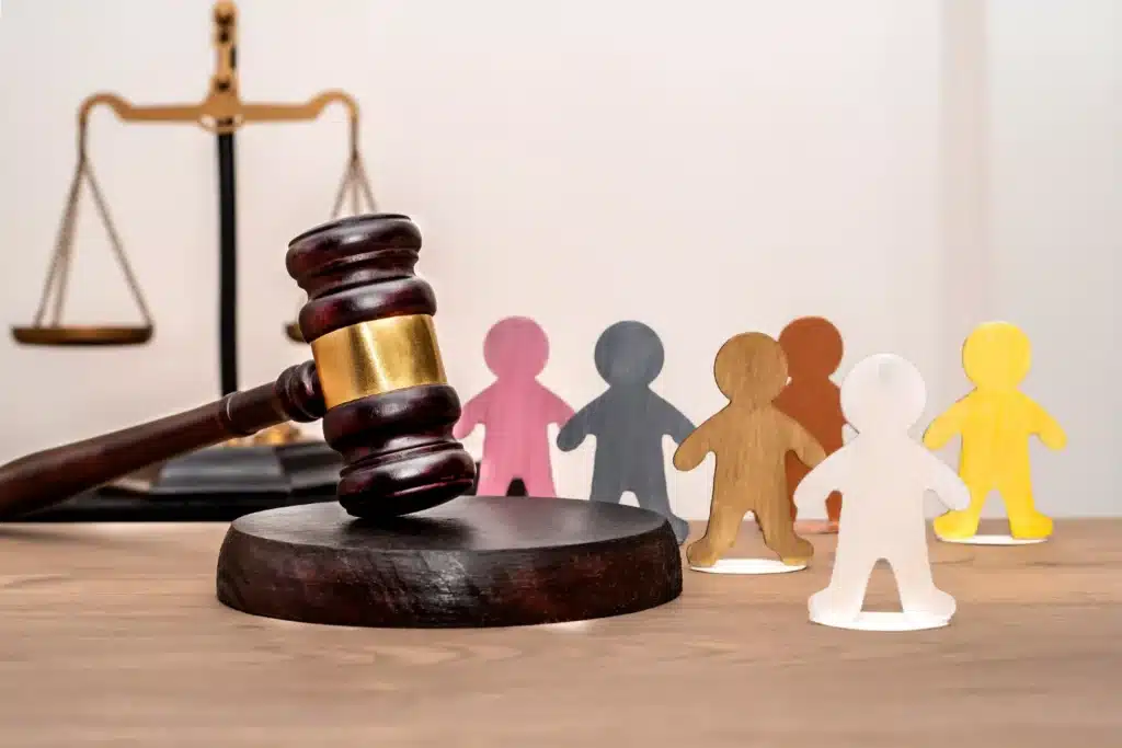 gavel-scales-and-figures-on-wooden-table-