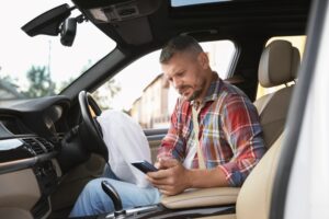 A man is looking on the phone after a truck accident, wondering how long he has to file a lawsuit in Louisiana