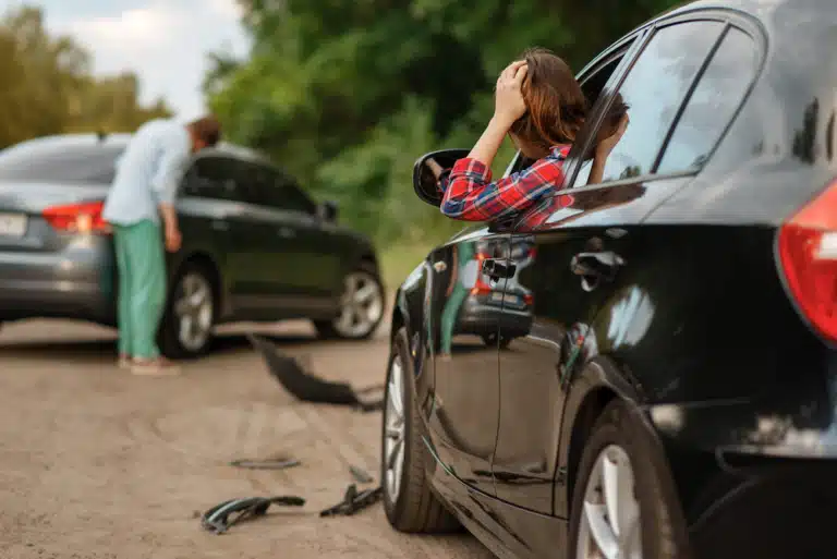 An image of a car accident of a female and male drivers