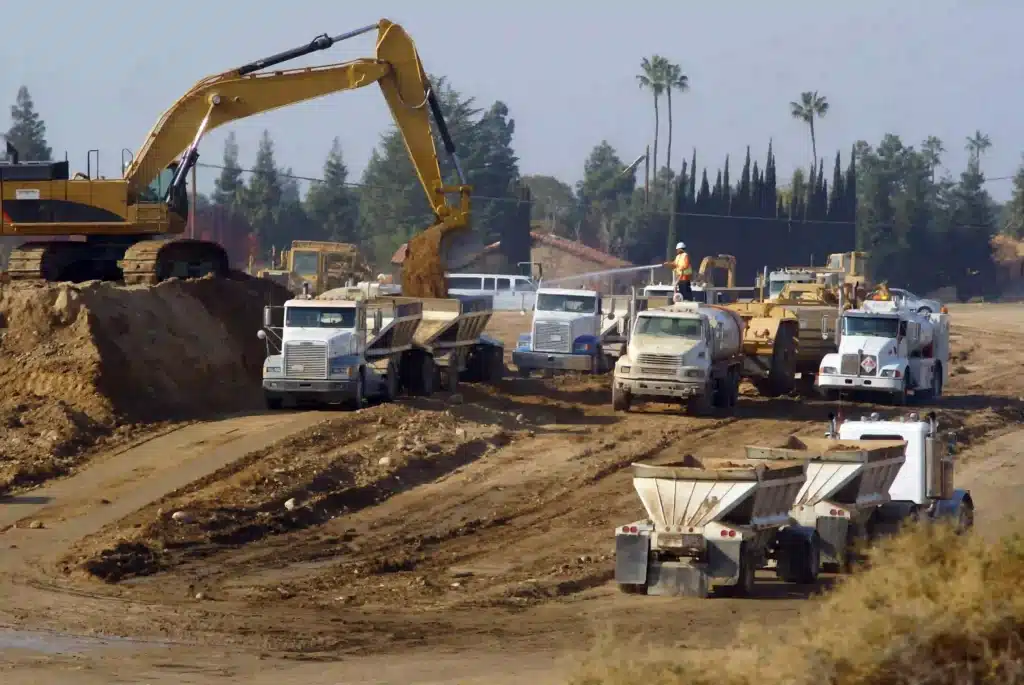 power-shovel-loads-trucks-on-site-of-new-highway-
