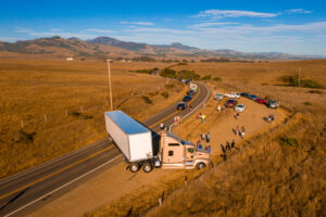The trailer of a semi-truck covers the road after an accident, leaving the victims to wonder how much most truck accident settlements in Louisiana are worth.