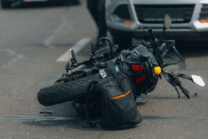 Motorcycle lying on its side after a crash, leaving the rider to wonder how much you can sue for a motorcycle accident in Louisiana.