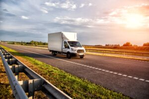 A white truck driving down the highway, symbolizing what to do if you’re in an accident with a budget truck in Louisiana.