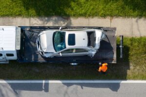A damaged car being towed away after one of the most common causes of car accidents in Louisiana