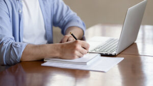 A New Orleans car accident lawyer looking at a lawsuit while sitting on his desk.