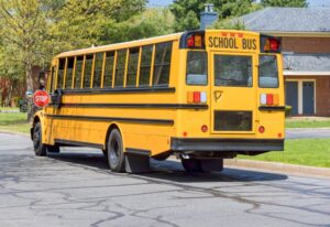 A school bus picking up passengers. What happens if a school bus hits my parked car?