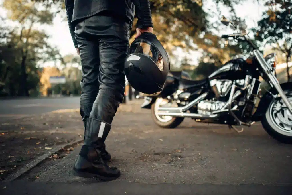 biker-with-helmet-near-motorcycle-outdoors
