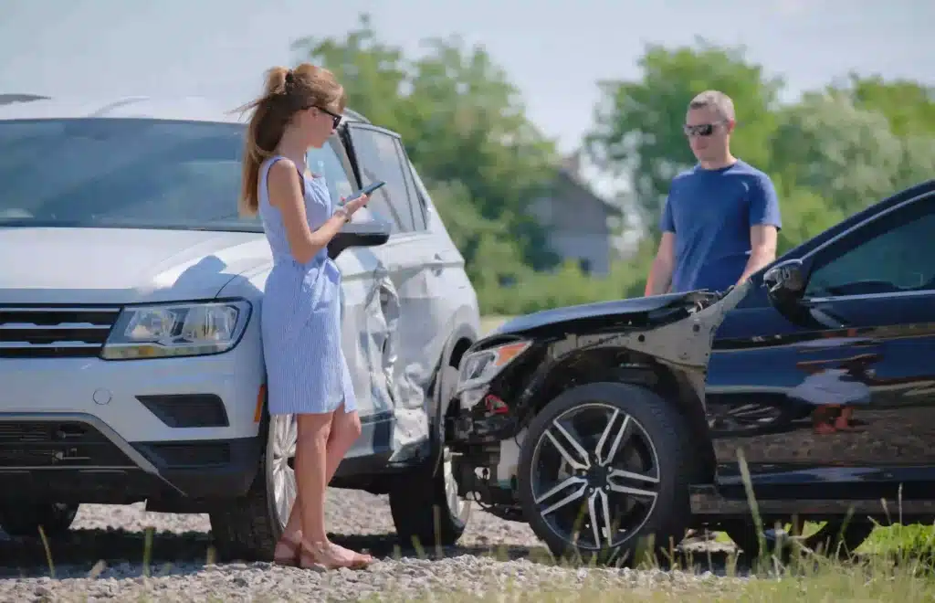 woman-with-damaged-car-talking-on-cellphone-