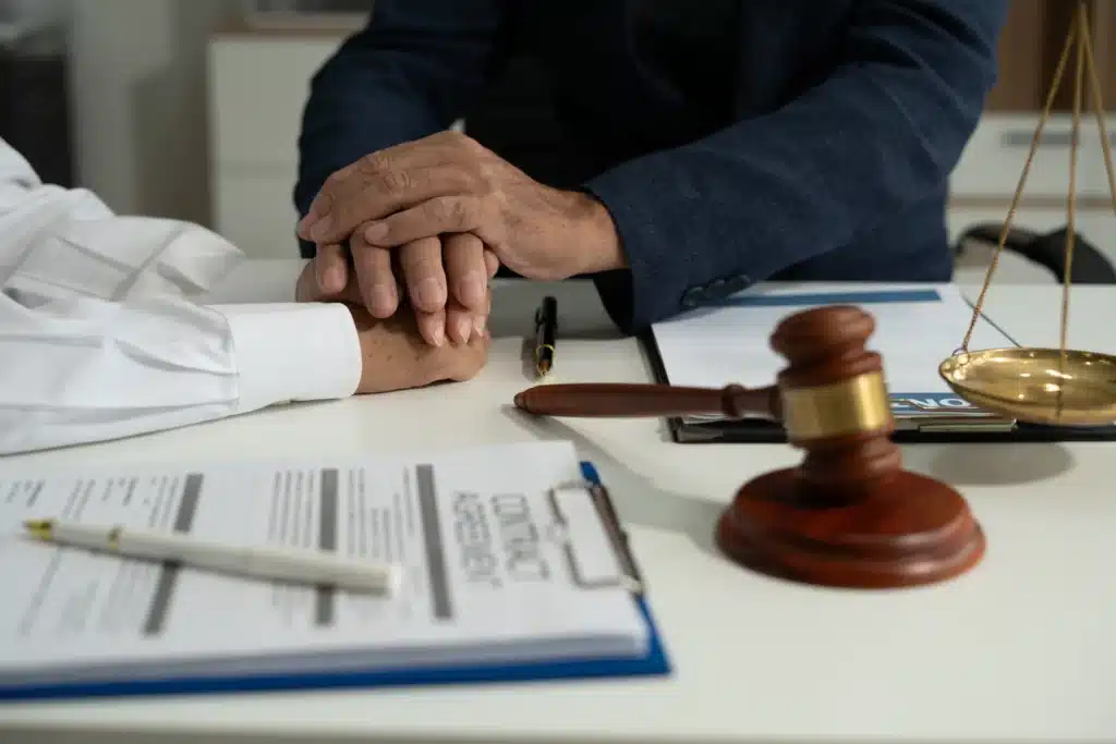 lawyer-holding-hands-with-senior-for-support-