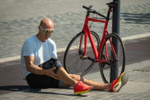 A man holding his knee after a bicycle accident in New Orleans. What damages can I recover from a bicycle accident in New Orleans?