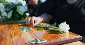 A woman placing a white rose on a coffin. What is the statute of limitations for wrongful death cases in Louisiana?