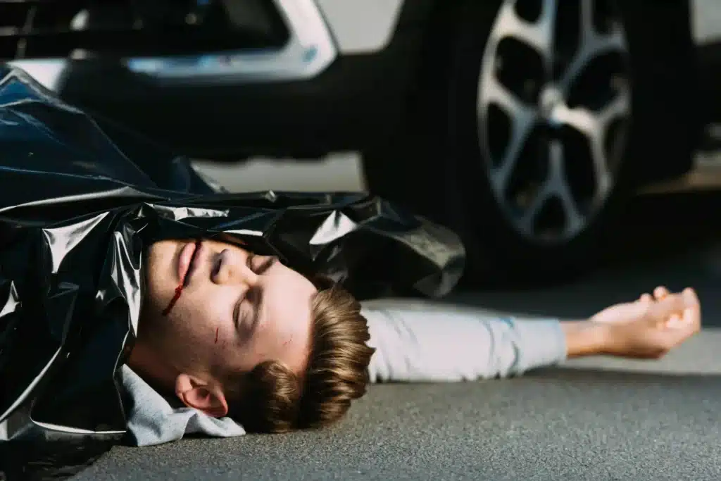 Young Man Lying on Street After Accident