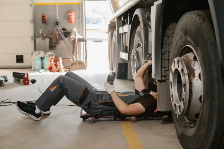 Mechanic Repairs Large Truck in Dusty Garage