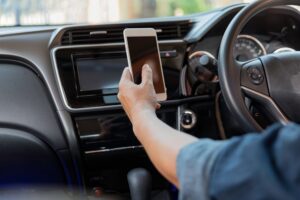 A man texting while driving. What steps should I take after a distracted driving accident?