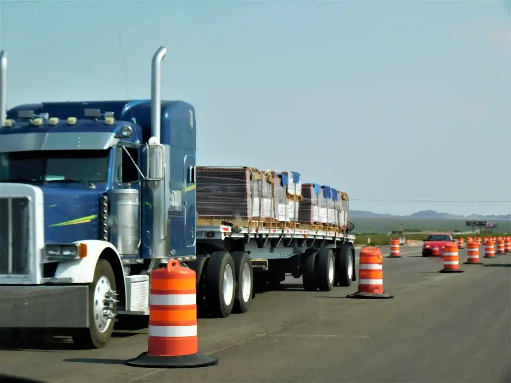 Blue Semi-Truck Hauling Materials on Highway Road