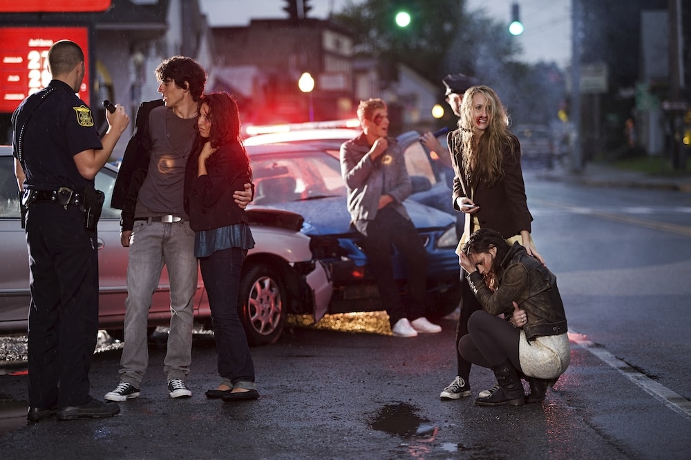 car accident with passengers standing nearby