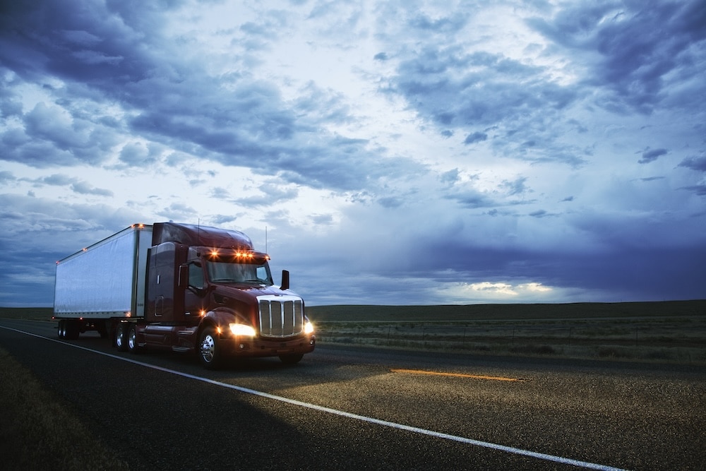 truck driving long open road