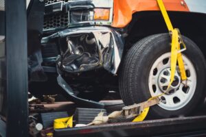 The damaged front-end of a truck. Why do truck rollovers happen?