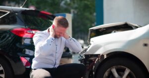 A man holding his neck after a car accident. How much is the average settlement for a rear-end car accident in Louisiana?