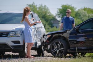 A man and a woman talking after a T-bone car accident. What types of injuries are common in T-Bone car accidents?