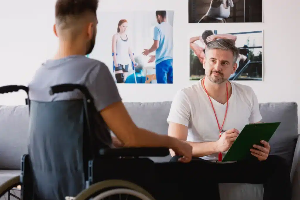 Man in Wheelchair Discussing Health with a Vocational Rehabilitation Counselor