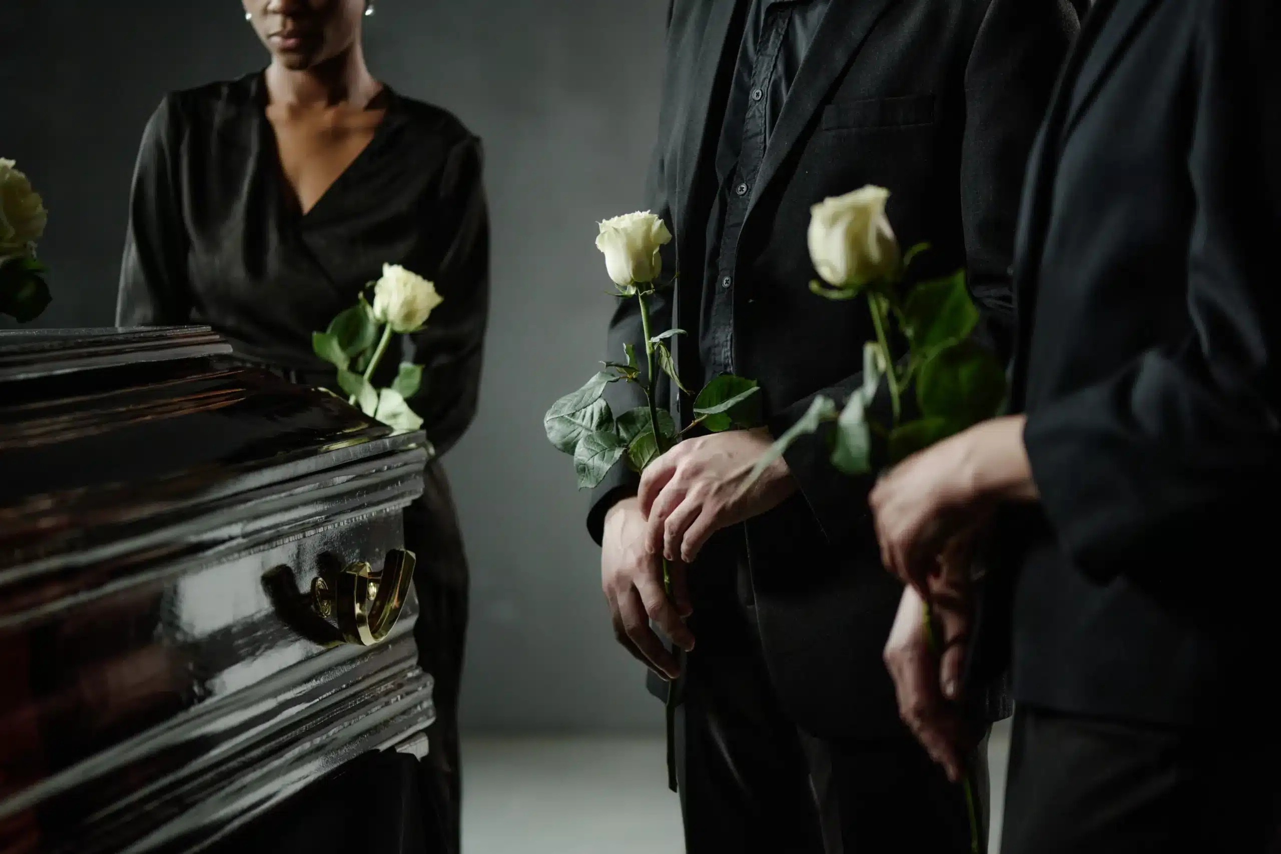 mourners standing by casket