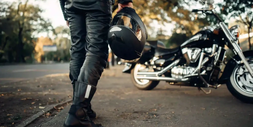 biker-with-helmet-near-motorcycle-outdoors