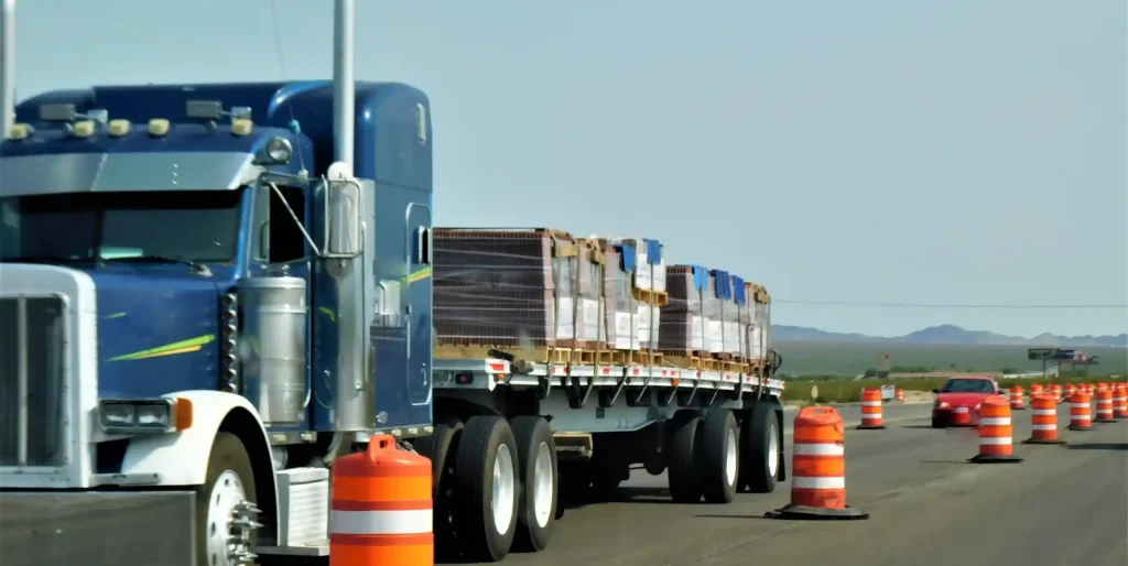 Blue Semi-Truck Hauling Materials on Highway Road