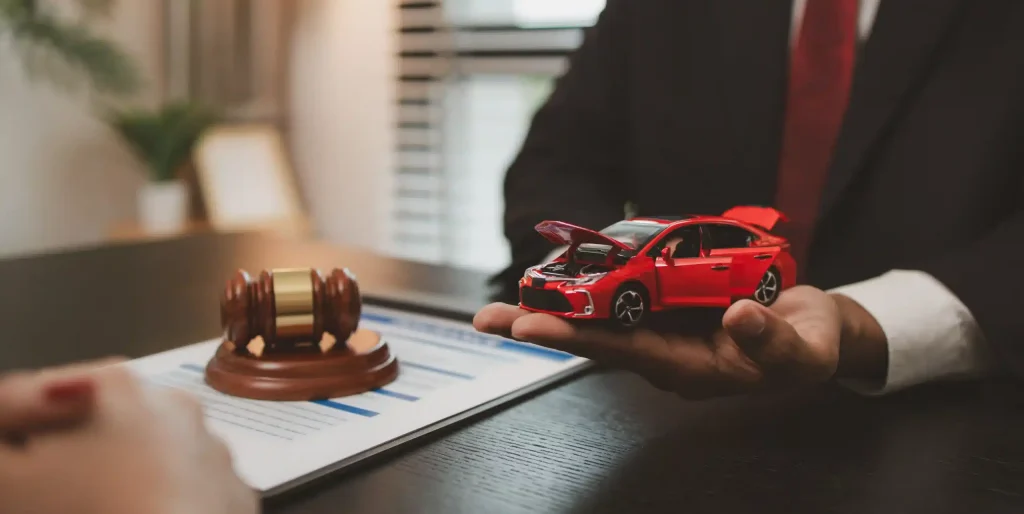 car-accident-lawsuit-with-gavel-and-toy-car-