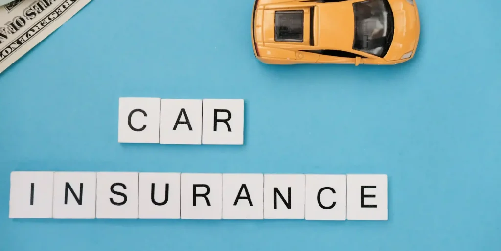 Car Insurance Concept with Model Car and Money