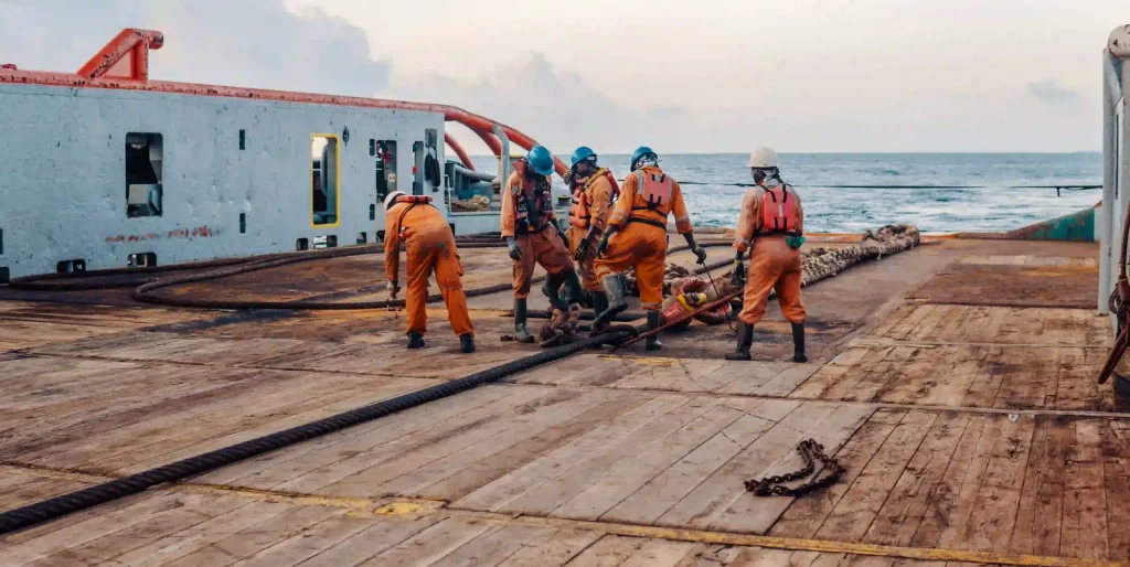 crew-working-with-ropes-on-ship-deck-