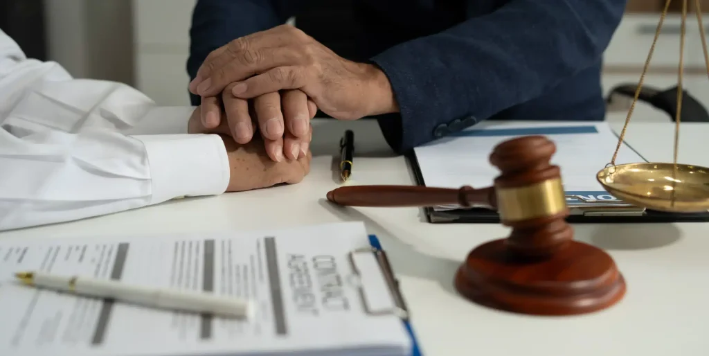 lawyer-holding-hands-with-senior-for-support-