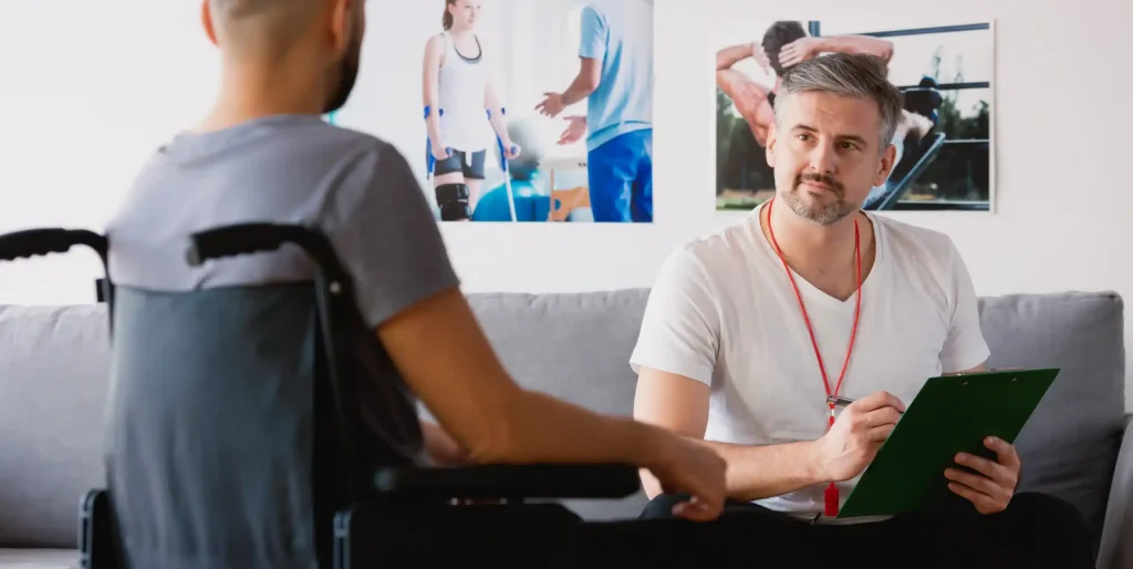 Man in Wheelchair Discussing Health with a Vocational Rehabilitation Counselor