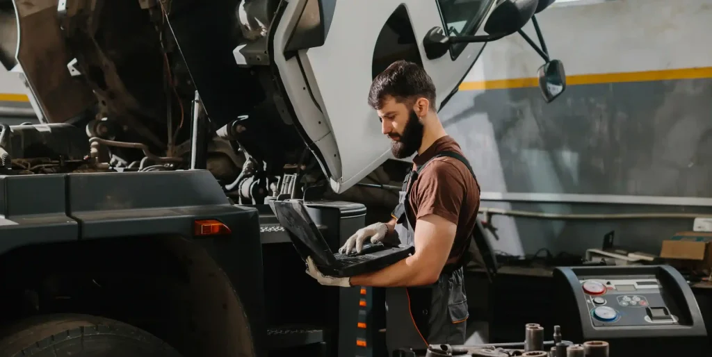 mechanic-using-laptop-to-diagnose-truck-problem