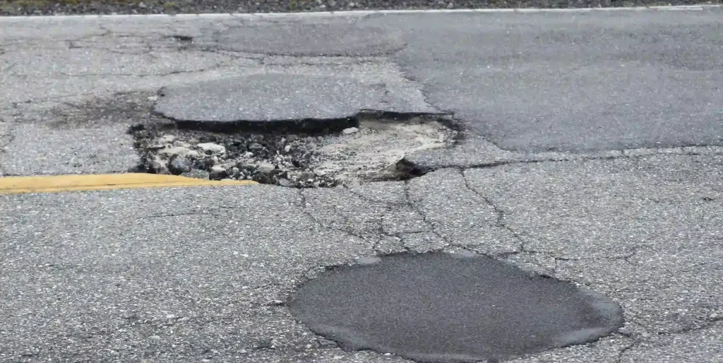 Pothole Damage on Gray Asphalt Road Surface