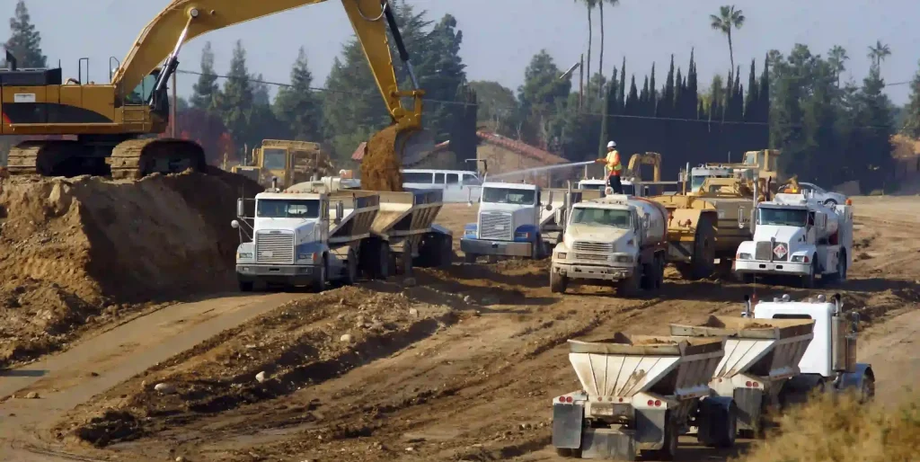 power-shovel-loads-trucks-on-site-of-new-highway-