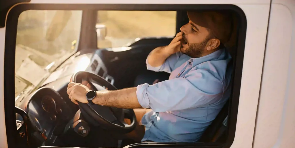 Truck Driver Tired and Yawning Inside Truck