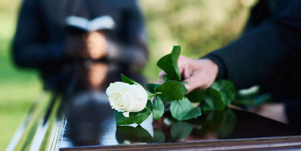 white-rose-on-a-dark-wooden-casket